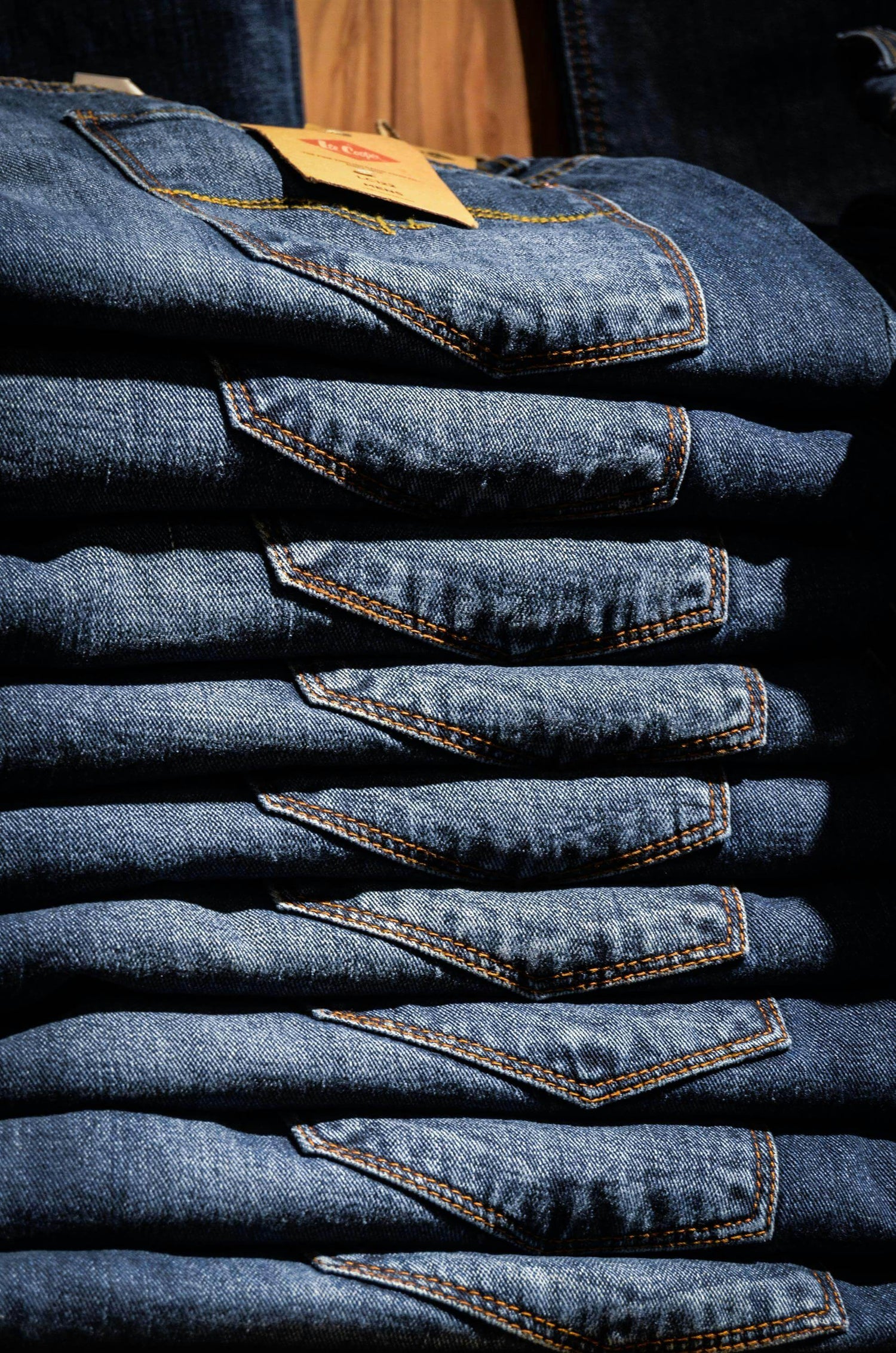 Stacked pairs of Jeans showcasing different styles and washes.